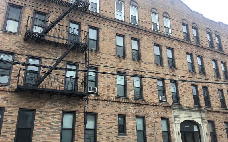 104-35 102nd Street, a brick walk-up apartment building in Ozone Park, Queens