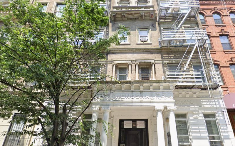 141 West 111th Street, a pre-war West Harlem multifamily building with a columned entrance