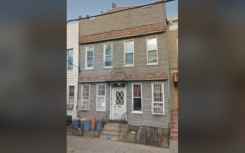 18-71 Gates Avenue, a two-story Ridgewood rowhouse with a stoop entrance