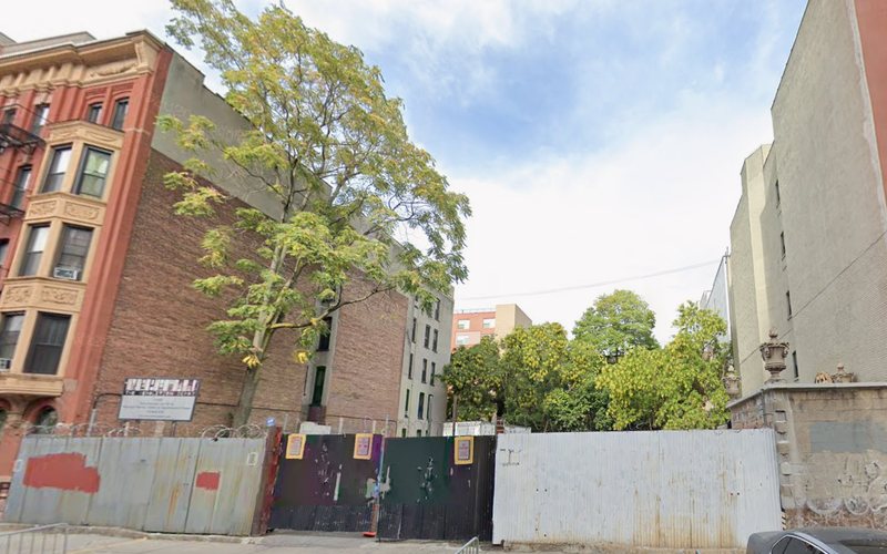 The 213-215 East 124th Street development site in East Harlem, hoarded and cleared
