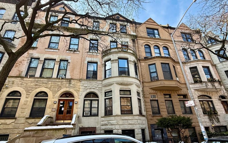 46 West 87th Street, an Upper West Side walk-up with a rounded limestone bay, seen from across the street on a winter afternoon