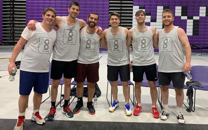 Six players in Dusk Group jerseys on the court after a game